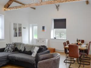 a living room with a couch and a table at Katellen Cottage in Threlkeld