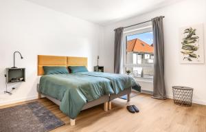Un pat sau paturi într-o cameră la TVL Apartments - modern, zentral und haustierfreundlich in Bad Zwischenahn