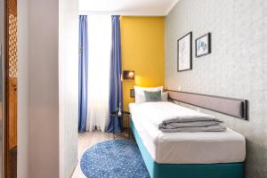 Postel nebo postele na pokoji v ubytování Garner Hotel Vienna by IHG