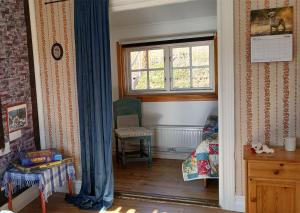 a room with a window and a chair in it at Hus Hammerstrand in Hammarstrand