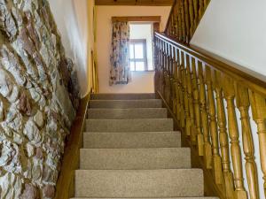 a staircase in a house with a stone wall at Castle House Cottage in Kirkby Stephen +5 photos