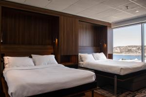 Postel nebo postele na pokoji v ubytování Hotel Chicoutimi, affilié à Hyvi