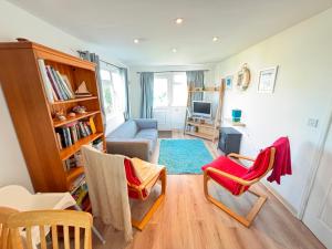 a living room with two chairs and a couch at Trevone - Chalet 130 in Padstow