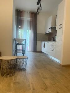 a kitchen with a table and two stools in a room at airport room -1 in Azzano San Paolo +24 photos