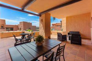 a patio with a table and chairs and a piano at Coto Real Apartment with Pools & Big Terrace in Manilva