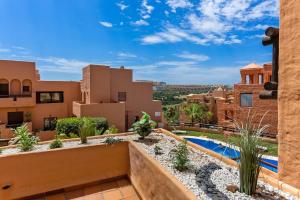 a view from the balcony of a house with a swimming pool at Coto Real Apartment with Pools & Big Terrace in Manilva