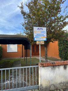 a sign in front of a house at Mughetto in Bibione