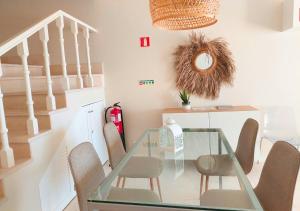 a dining room with a glass table and chairs at Praia da Rocha in Portimão +22 photos