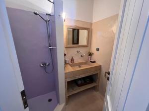 a bathroom with a sink and a shower with a mirror at Holiday House - Koundouros Panoramic Sea View in Koundouros +41 photos