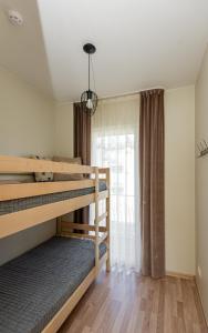 a bedroom with two bunk beds and a window at Vila Dia Palanga in Palanga