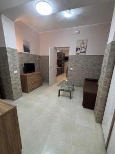 a living room with a couch and a tv at Pancho House Catania in Catania