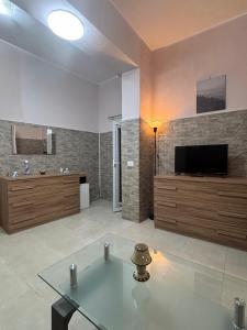 a living room with a flat screen tv on a wall at Pancho House Catania in Catania