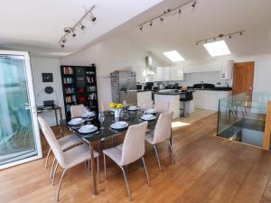 a kitchen and dining room with a table and chairs at Gwelfor, Marloes in Haverfordwest