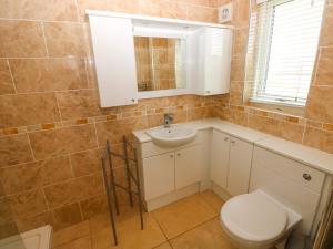 a bathroom with a toilet and a sink at Gwelfor, Marloes in Haverfordwest +32 photos