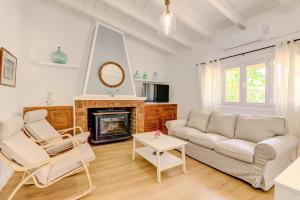 a living room with a couch and a fireplace at Can Amer Ref 256 in S'Illot