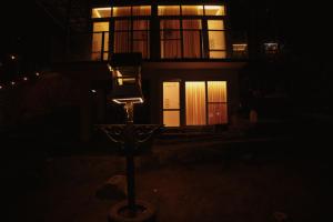a street light in front of a house at night at Wildenest in Kanjikode
