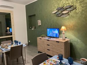 a living room with a tv on top of a dresser at La Rosa Blu in San Vito lo Capo