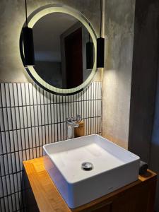 a bathroom with a white sink and a mirror at Flex Living Canggu in Canggu +88 photos