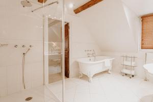a white bathroom with a tub and a shower at Saint James in Trouville-sur-Mer +42 photos