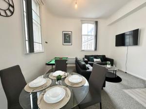 a living room with a dining room table with a pool table at City Haven - Modern 2 Bedroom in Sheffield in Sheffield