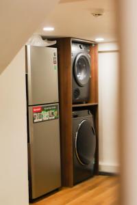 a refrigerator and a tv in a room at Katoya Suites Saigon Honkan 加藤部屋西貢本館 in Ho Chi Minh City