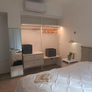 a bedroom with a bed and a desk with two speakers at Onda d'Oro in Finale Ligure