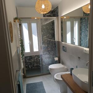 a bathroom with a shower and a toilet and a sink at Onda d'Oro in Finale Ligure +15 photos
