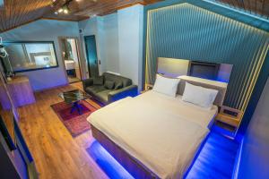 a bedroom with a large bed and a chair at Royal Nest in Istanbul +30 photos