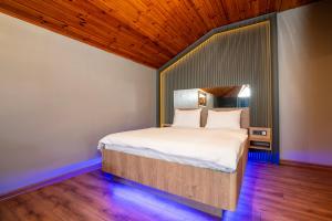 a bed in a room with a wooden ceiling at Royal Nest in Istanbul