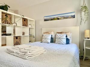 a bedroom with a bed with towels on it at Studio Polvo in Parede +15 photos