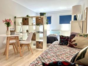 a living room with a table and a couch and a table and chairs at Studio Polvo in Parede