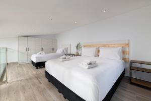 a large bedroom with two beds and a bathroom at Stone Apartments in Kremasti