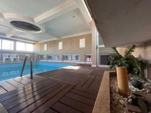 a swimming pool in a large building with a pool at Hotel Nações Plaza in Bauru