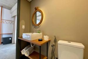 a bathroom with a sink and a mirror and a toilet at 9006 Suites Natal Hotel in Natal +36 photos