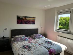 Postel nebo postele na pokoji v ubytování Bungalow Noordzee E