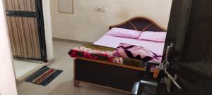 a bedroom with a bed with a wooden frame at Hotel R K Palace in Rewa