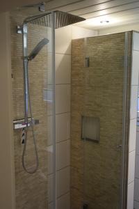 a shower with a glass door in a bathroom at Ferienhaus Günter in Baiersbronn