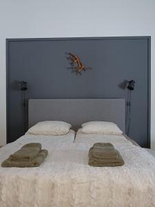 a bedroom with a bed with two towels on it at Kontion keidas Maaseudulla Varattavissa myös Takkatupa ja Sauna in Oulu