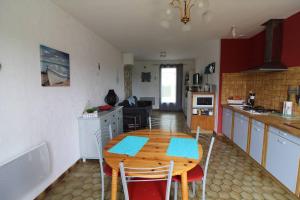 a kitchen with a wooden table and chairs in a room at Maison 3 pièces Oléron 6 couchages SAINT GEORGES D'OLERON SGO000-434 in Saint-Georges-dʼOléron +8 photos