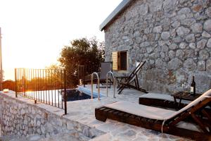 a stone house with a pool and a patio at Old stone house with swimming pool Etno House Perazic in Bar