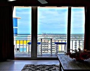 a balcony with two stools and a view of the ocean at Totally Updated 1 BR Deluxe Jacuzzi Suite - Wyndham Ocean Walk 2429 - Vacation in Resort luxury in Daytona Beach +57 photos