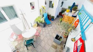 an aerial view of a patio with chairs and plants at VILLA JULIETTE in Dunkerque
