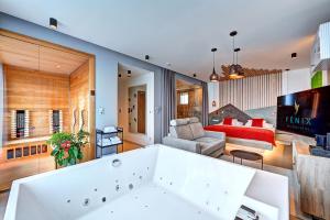 利贝雷茨Wellness Hotel Fénix的带浴缸的房间和客厅
