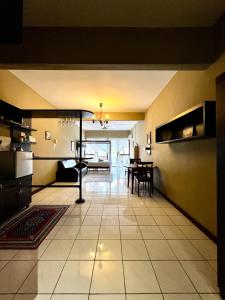 a living room with a table and a large room at The Studio Apartment at Selesa Hillhomes Bukit Tinggi Bentong in Bentong