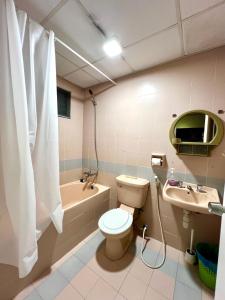 a bathroom with a toilet and a sink and a tub at The Studio Apartment at Selesa Hillhomes Bukit Tinggi Bentong in Bentong