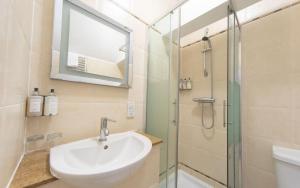 a bathroom with a sink and a shower at Heacham Manor Hotel in Hunstanton
