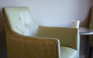 a chair in a room with a table at Heacham Manor Hotel in Hunstanton