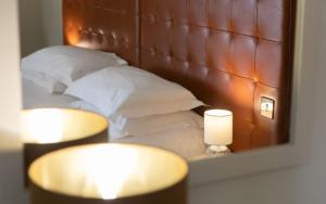 a reflection of a bed with pillows in a mirror at Heacham Manor Hotel in Hunstanton
