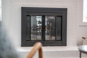 a black window in a white brick fireplace at Tranquil Light-Filled Retreat 3BR Ranch in Durham