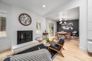 a living room with a fireplace and a table at Tranquil Light-Filled Retreat 3BR Ranch in Durham +65 photos